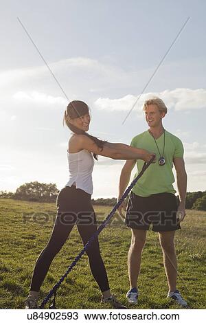 Personal trainer and female client doing stretch exercise View Large Photo Image Stock Image - Personal trainer and female client doing stretch exercise. Fotosearch