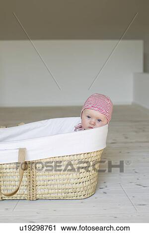 Portrait of baby girl in moses basket View Large Photo Image Stock Image - Portrait of baby girl in moses basket. Fotosearch