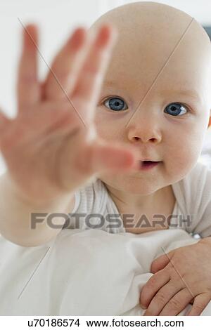 Portrait of baby girl reaching towards camera View Large Photo Image Picture - Portrait of baby girl reaching towards camera. Fotosearch