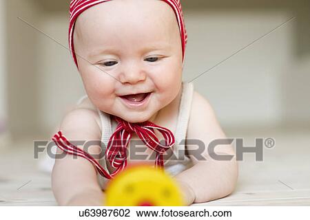 Stock Image - Portrait of baby girl smiling. Fotosearch