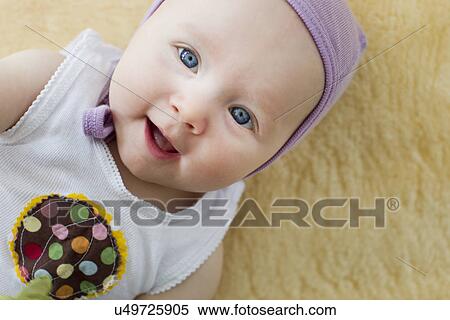 Stock Photography - Portrait of baby girl with blue eyes. Fotosearch