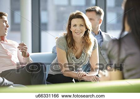 Stock Photograph - Portrait of business colleagues in meeting. Fotosearch