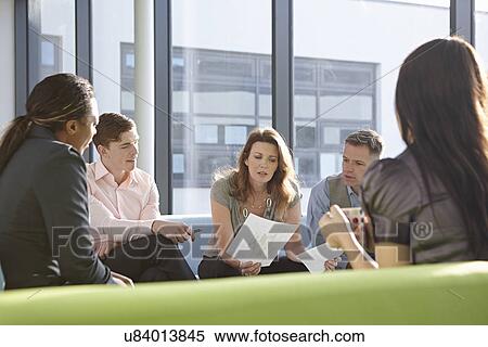 Stock Photography - Portrait of business colleagues in meeting. Fotosearch