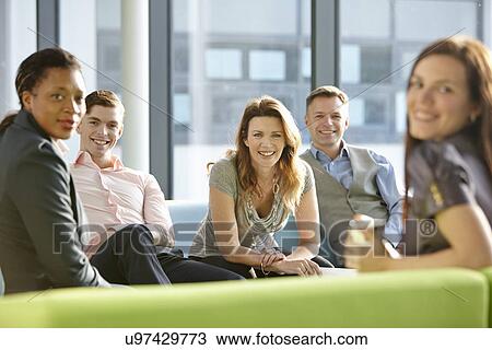Stock Image - Portrait of business colleagues smiling. Fotosearch