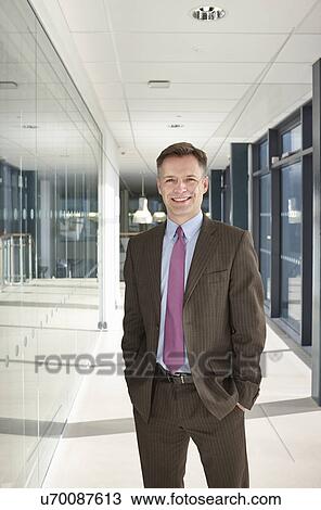 Portrait of businessman in corridor View Large Photo Image Stock Image - Portrait of businessman in corridor. Fotosearch