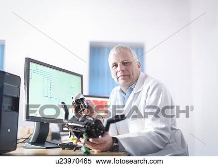 Stock Photography - Portrait of engineer designing electronic circuitry for automotive use. Fotosearch