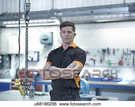 Portrait of engineer in engineering factory View Large Photo Image Stock Photograph - Portrait of engineer in engineering factory. Fotosearch