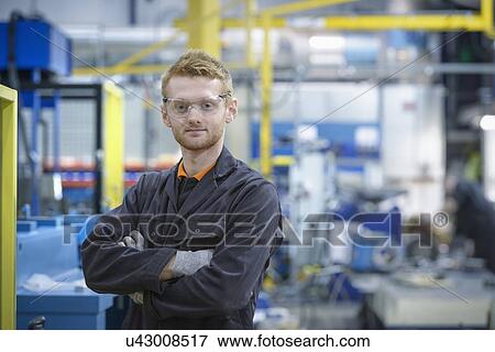 Portrait of engineering apprentice in engineering factory View Large Photo Image Stock Photo - Portrait of engineering apprentice in engineering factory. Fotosearch