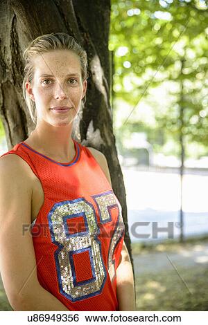 Stock Photograph - Portrait of female basketball player in park. Fotosearch