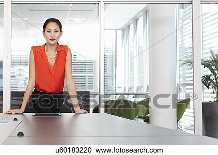 Portrait of female business manager in office View Large Photo Image Stock Image - Portrait of female business manager in office. Fotosearch