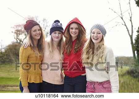 Picture - Portrait of four teenage girls in knitted hats. Fotosearch
