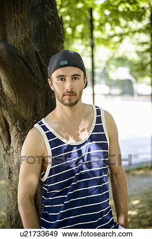 Stock Photo - Portrait of male basketball player in park. Fotosearch