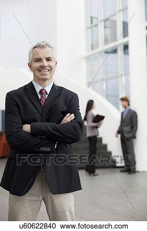 Portrait of mature businessman in office atrium View Large Photo Image Stock Image - Portrait of mature businessman in office atrium. Fotosearch