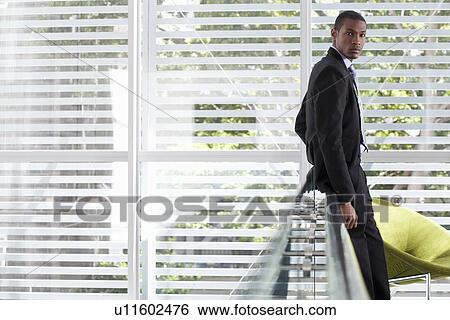 Portrait of mid adult businessman on office balcony View Large Photo Image Stock Photograph - Portrait of mid adult businessman on office balcony. Fotosearch