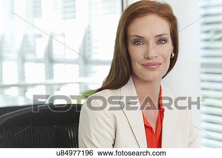 Portrait of mid adult businesswoman in office View Large Photo Image Stock Photograph - Portrait of mid adult businesswoman in office. Fotosearch