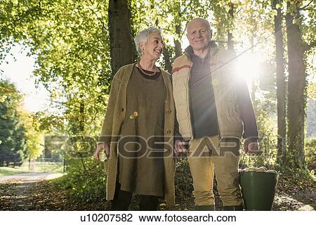 Portrait of senior couple with bucket of apples View Large Photo Image Stock Image - Portrait of senior couple with bucket of apples. Fotosearch