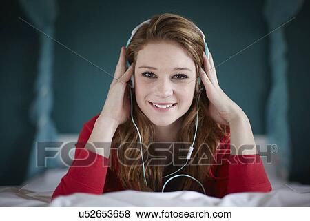 Portrait of teenage girl in bedroom listening to music View Large Photo Image Stock Photo - Portrait of teenage girl in bedroom listening to music. Fotosearch
