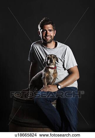 Portrait of winemaker and his dog sitting on wine barrel View Large Photo Image Picture - Portrait of winemaker and his dog sitting on wine barrel. Fotosearch