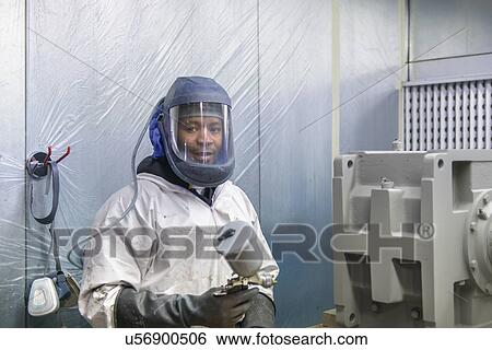 Portrait of worker preparing to paint spray industrial gearboxes in factory View Large Photo Image Stock Photograph - Portrait of worker preparing to paint spray industrial gearboxes in factory. Fotosearch