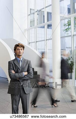 Portrait of young businessman in office atrium View Large Photo Image Stock Photo - Portrait of young businessman in office atrium. Fotosearch