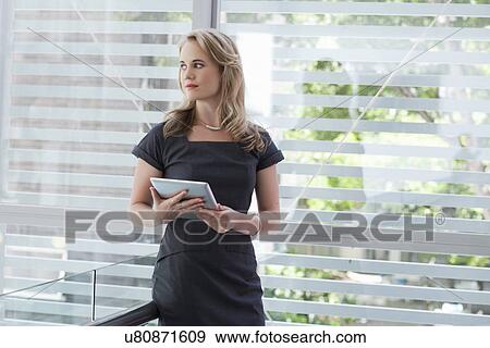 Portrait of young businesswoman holding digital tablet View Large Photo Image Stock Photo - Portrait of young businesswoman holding digital tablet. Fotosearch