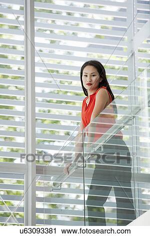 Portrait of young businesswoman on office balcony View Large Photo Image Stock Image - Portrait of young businesswoman on office balcony. Fotosearch