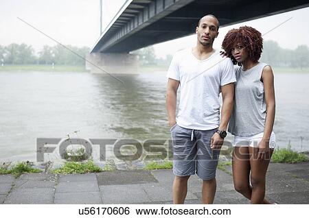Portrait of young couple by bridge, Dusseldorf, Germany View Large Photo Image Stock Photograph - Portrait of young couple by bridge, Dusseldorf, Germany. Fotosearch