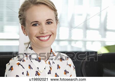Portrait of young female office worker View Large Photo Image Stock Image - Portrait of young female office worker. Fotosearch