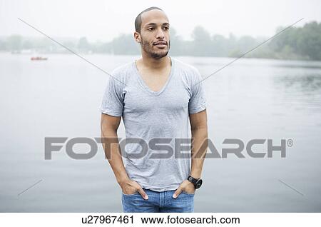 Portrait of young man by lake View Large Photo Image Stock Image - Portrait of young man by lake. Fotosearch