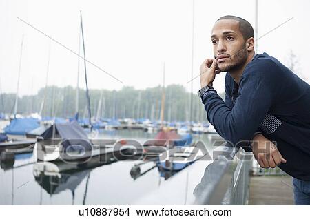 Picture - Portrait of young man in marina. Fotosearch