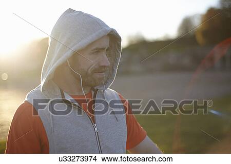 Portrait of young man wearing hooded top View Large Photo Image Picture - Portrait of young man wearing hooded top. Fotosearch