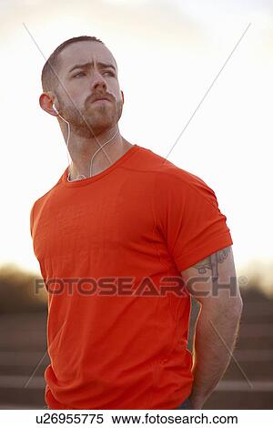 Portrait of young man wearing orange t shirt View Large Photo Image Stock Photography - Portrait of young man wearing orange t shirt. Fotosearch