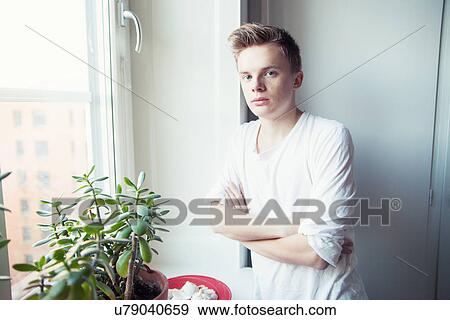 Portrait of young man with arms folded View Large Photo Image Stock Photo - Portrait of young man with arms folded. Fotosearch