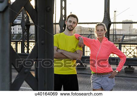 Portrait of young running couple on bridge View Large Photo Image Stock Photo - Portrait of young running couple on bridge. Fotosearch