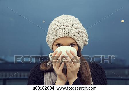 Picture - Portrait of young woman drinking a cup of coffee. Fotosearch