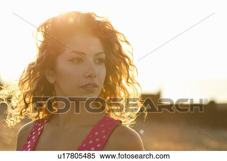 Stock Photography - Portrait of young woman in sunlight. Fotosearch