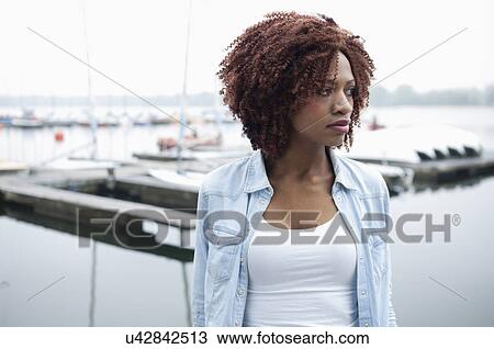 Portrait of young woman looking away View Large Photo Image Stock Image - Portrait of young woman looking away. Fotosearch