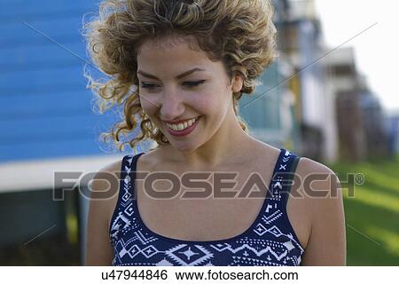 Portrait of young woman looking down View Large Photo Image Stock Photograph - Portrait of young woman looking down. Fotosearch