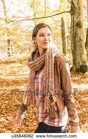 Portrait of young woman wearing knitted scarf View Large Photo Image Stock Image - Portrait of young woman wearing knitted scarf. Fotosearch
