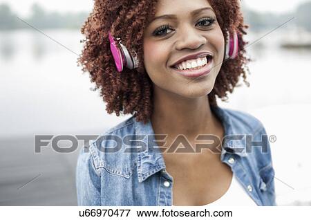 Portrait of young woman wearing headphones View Large Photo Image Stock Photo - Portrait of young woman wearing headphones. Fotosearch