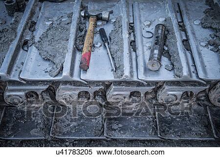 Stock Photography - Repairs being made to bulldozer tracks at surface coal mine, close up. Fotosearch