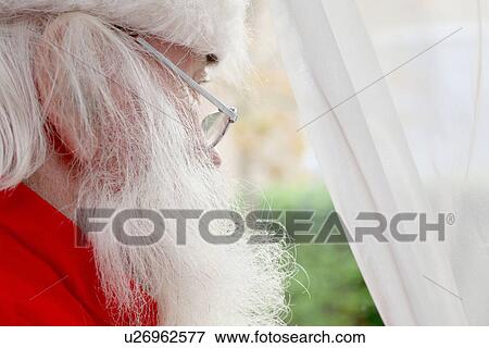 Santa Claus looking out of window View Large Photo Image Stock Photo - Santa Claus looking out of window. Fotosearch