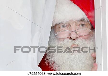 Santa Claus looking out of window View Large Photo Image Stock Photo - Santa Claus looking out of window. Fotosearch