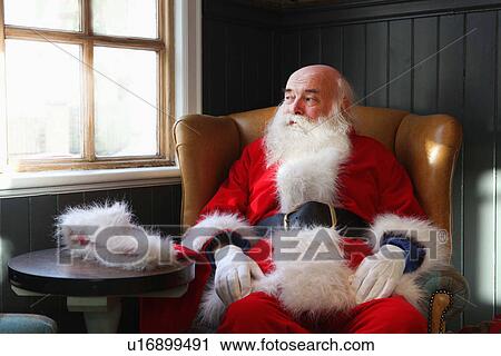 Santa Claus taking break in armchair View Large Photo Image Stock Image - Santa Claus taking break in armchair. Fotosearch
