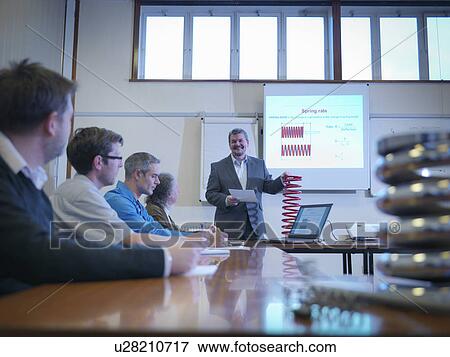 Scientist giving lecture about spring technology in conference room View Large Photo Image Stock Photo - Scientist giving lecture about spring technology in conference room. Fotosearch