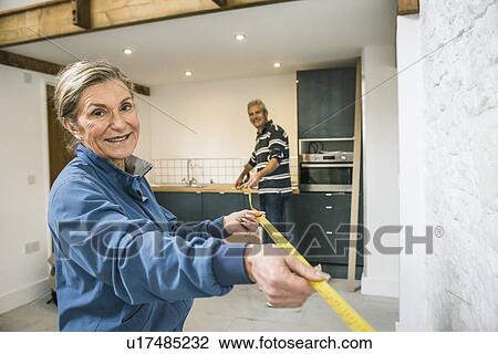 Senior couple doing DIY, using measuring tape View Large Photo Image Stock Image - Senior couple doing DIY, using measuring tape. Fotosearch