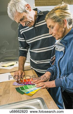 Senior couple holding colour charts View Large Photo Image Stock Image - Senior couple holding colour charts. Fotosearch