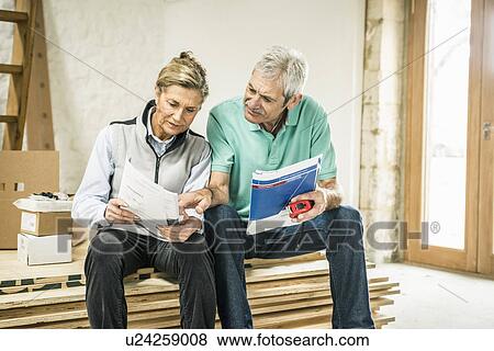Senior couple reading manual View Large Photo Image Stock Photo - Senior couple reading manual. Fotosearch