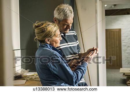 Stock Image - Senior couple using digital tablet. Fotosearch