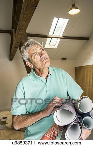 Senior man carrying rolls of wallpaper View Large Photo Image Stock Image - Senior man carrying rolls of wallpaper. Fotosearch
